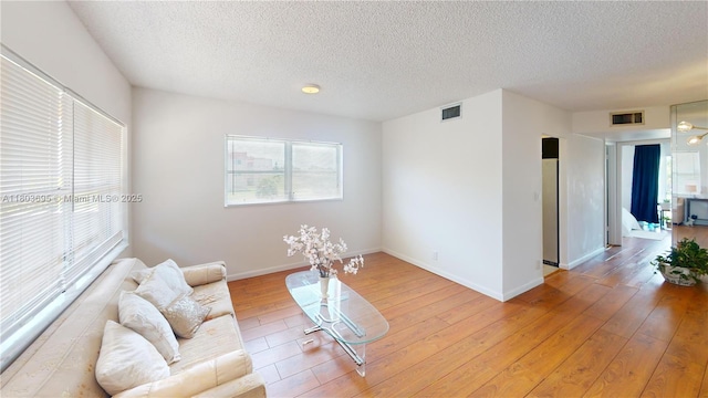 9121 Sunrise Lakes Blvd Unit 201, Sunrise, FL 33322 - living room featuring light wood-style flooring, a textured ceiling, and baseboards