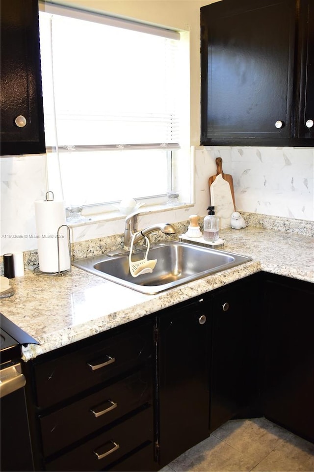 9121 Sunrise Lakes Blvd Unit 201, Sunrise, FL 33322 - kitchen with dark cabinetry, a sink, light countertops, and tile patterned flooring
