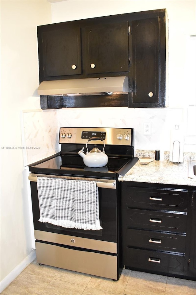9121 Sunrise Lakes Blvd Unit 201, Sunrise, FL 33322 - kitchen with stainless steel electric range oven, under cabinet range hood, light stone counters, baseboards, and light tile patterned floors
