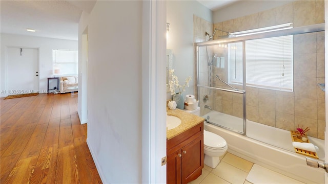 9121 Sunrise Lakes Blvd Unit 201, Sunrise, FL 33322 - bathroom with combined bath / shower with glass door, vanity, toilet, and hardwood / wood-style floors