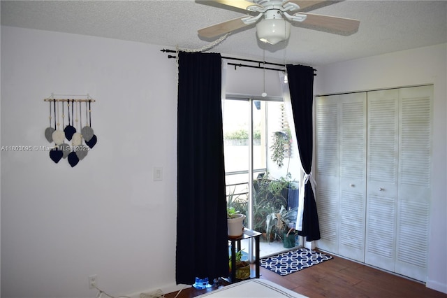 9121 Sunrise Lakes Blvd Unit 201, Sunrise, FL 33322 - bedroom featuring wood finished floors, a textured ceiling, a closet, and ceiling fan