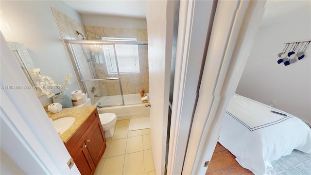 9121 Sunrise Lakes Blvd Unit 201, Sunrise, FL 33322 - bathroom with vanity, enclosed tub / shower combo, toilet, and tile patterned flooring