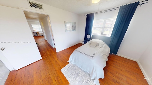 9121 Sunrise Lakes Blvd Unit 201, Sunrise, FL 33322 - bedroom with hardwood / wood-style flooring, baseboards, and a textured ceiling