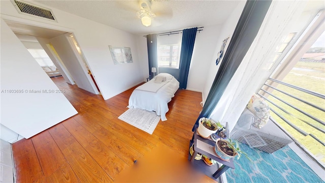 9121 Sunrise Lakes Blvd Unit 201, Sunrise, FL 33322 - bedroom featuring wood-type flooring, a ceiling fan, baseboards, and a textured ceiling
