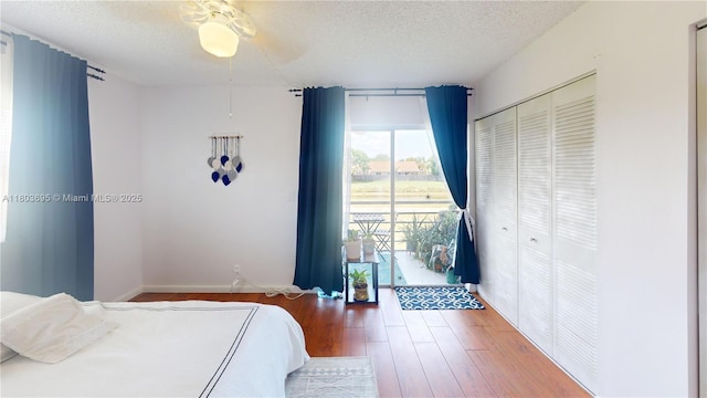 9121 Sunrise Lakes Blvd Unit 201, Sunrise, FL 33322 - bedroom featuring wood finished floors, a textured ceiling, baseboards, a closet, and a ceiling fan