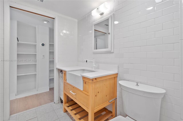 6886 N Kendall Dr Unit D207, Pinecrest, FL 33156 - bathroom featuring vanity, tile patterned flooring, tile walls, toilet, and a spacious closet