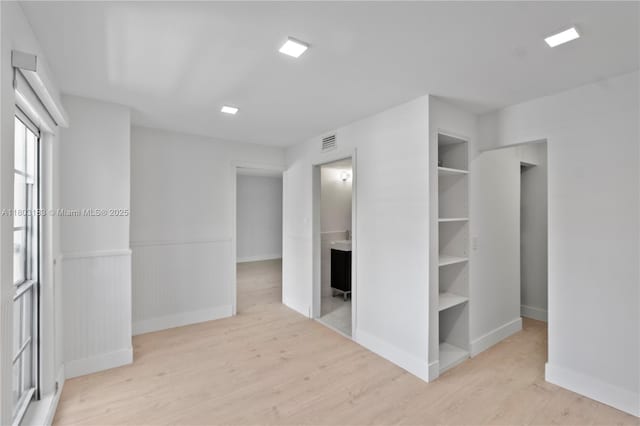 6886 N Kendall Dr Unit D207, Pinecrest, FL 33156 - unfurnished bedroom featuring wood finished floors, baseboards, and a wainscoted wall