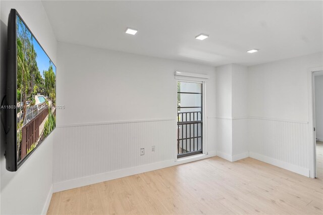 6886 N Kendall Dr Unit D207, Pinecrest, FL 33156 - empty room with wood finished floors, a wainscoted wall, and baseboards