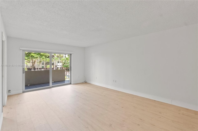 6886 N Kendall Dr Unit D207, Pinecrest, FL 33156 - empty room with wood finished floors, a textured ceiling, and baseboards