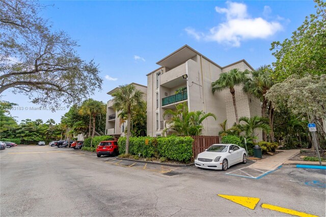 6886 N Kendall Dr Unit D207, Pinecrest, FL 33156 - view of building exterior with uncovered parking