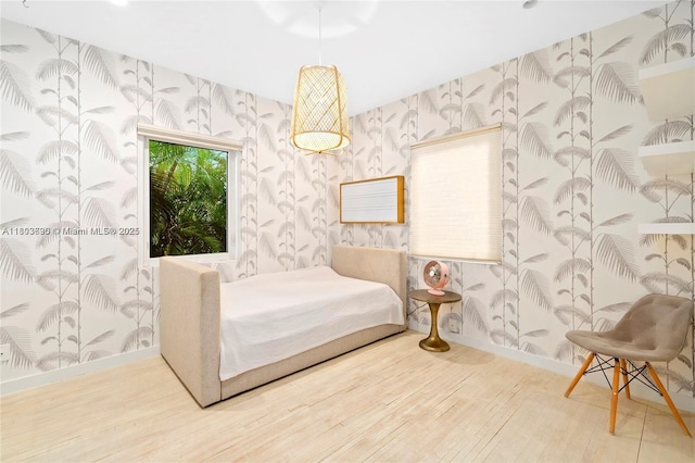 5120 Cherokee Ave, Miami Beach, FL 33140 - bedroom featuring wallpapered walls, wood finished floors, and baseboards