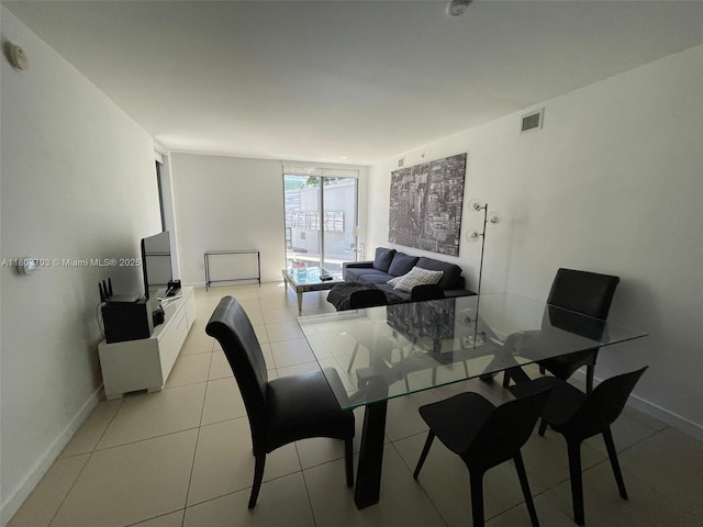 31 SE 6th St Unit 907, Miami, FL 33131 - dining area with a wall of windows, light tile patterned floors, and baseboards