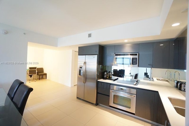 31 SE 6th St Unit 907, Miami, FL 33131 - kitchen featuring stainless steel appliances, light countertops, modern cabinets, a sink, and recessed lighting