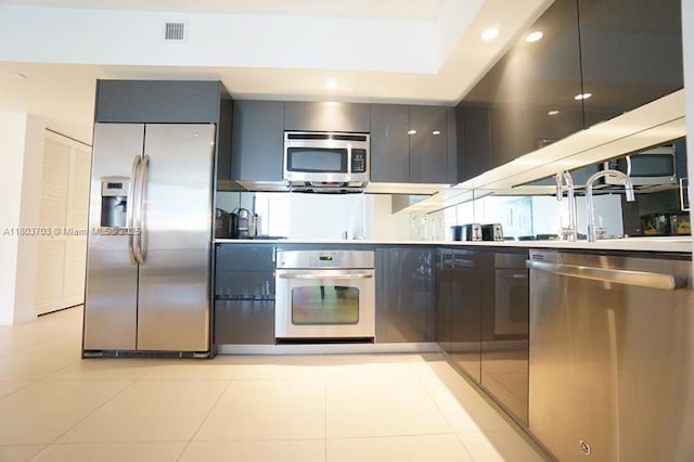 31 SE 6th St Unit 907, Miami, FL 33131 - kitchen with appliances with stainless steel finishes, modern cabinets, gray cabinets, recessed lighting, and light countertops