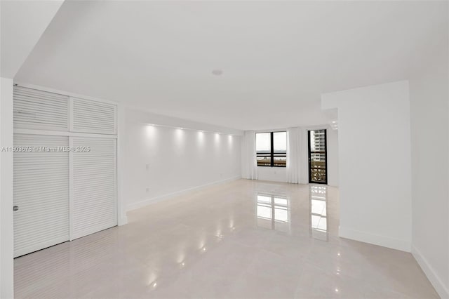 10185 Collins Ave Unit 1502, Bal Harbour, FL 33154 - unfurnished living room with baseboards