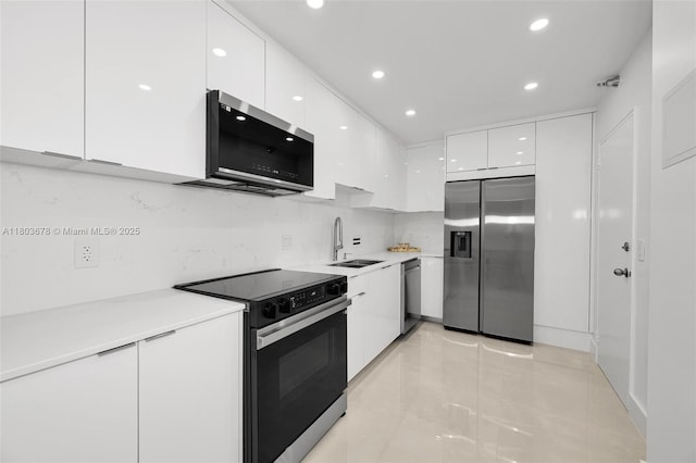 10185 Collins Ave Unit 1502, Bal Harbour, FL 33154 - kitchen with appliances with stainless steel finishes, modern cabinets, white cabinetry, a sink, and recessed lighting