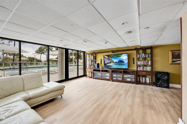 10185 Collins Ave Unit 1502, Bal Harbour, FL 33154 - living room with wood finished floors, baseboards, a paneled ceiling, and a wall of windows
