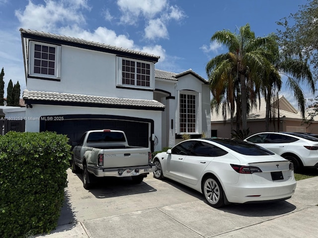 9740 SW 155th Ave, Miami, FL 33196 - mediterranean / spanish home featuring driveway, stucco siding, a tile roof, and an attached garage