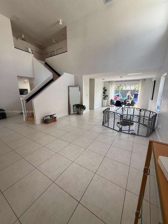 9740 SW 155th Ave, Miami, FL 33196 - living room featuring a towering ceiling, tile patterned flooring, and stairway