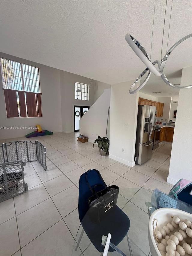 9740 SW 155th Ave, Miami, FL 33196 - living area featuring light tile patterned flooring, baseboards, and a textured ceiling