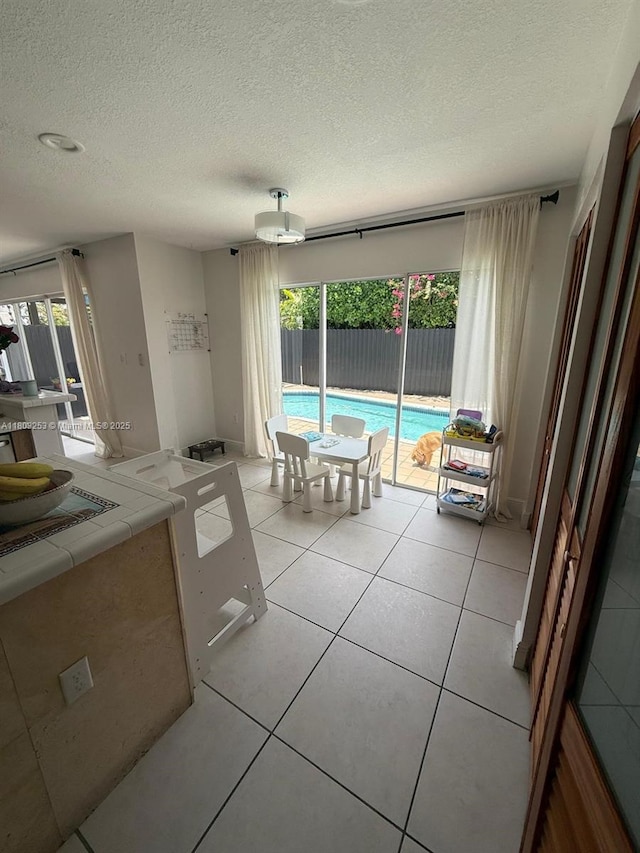 9740 SW 155th Ave, Miami, FL 33196 - dining space with a textured ceiling and light tile patterned floors