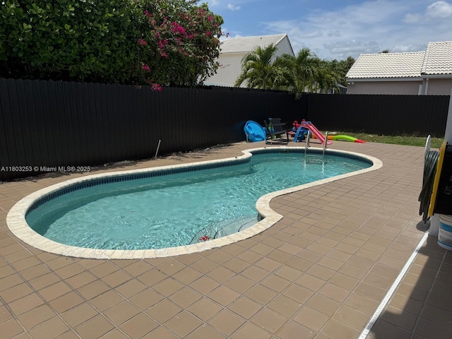 9740 SW 155th Ave, Miami, FL 33196 - view of swimming pool featuring a fenced backyard and a patio area