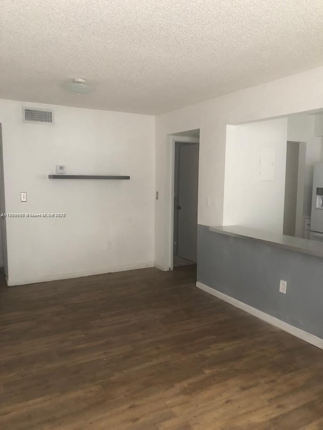 250 180th Dr Unit 108, Sunny Isles Beach, FL 33160 - spare room featuring a textured ceiling, wood finished floors, and baseboards