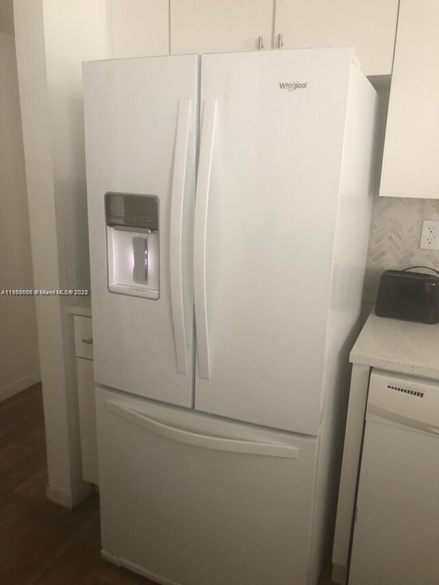 250 180th Dr Unit 108, Sunny Isles Beach, FL 33160 - kitchen view of white appliances, white cabinets, dark wood finished floors, light countertops, and backsplash