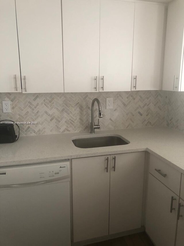 250 180th Dr Unit 108, Sunny Isles Beach, FL 33160 - kitchen featuring dishwasher, a sink, white cabinets, tasteful backsplash, and light stone countertops