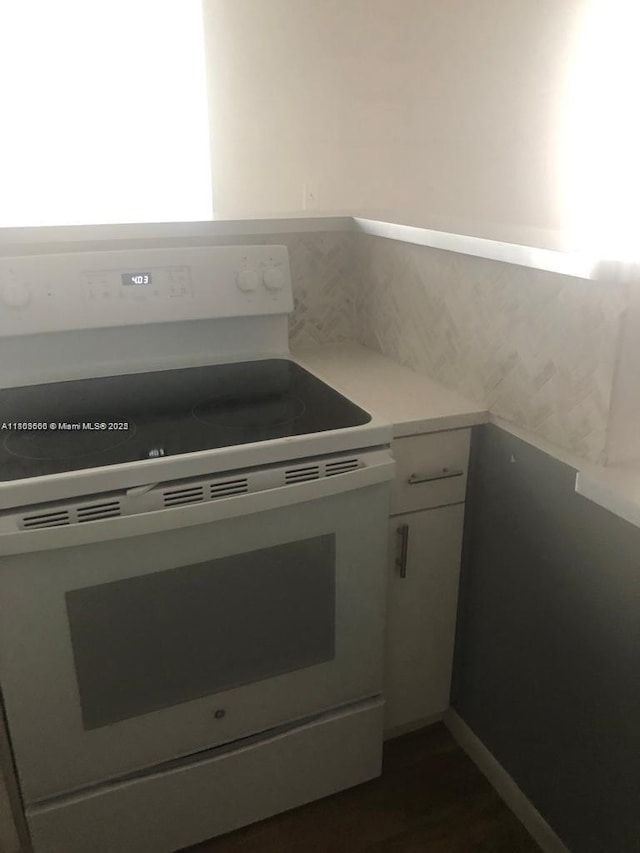 250 180th Dr Unit 108, Sunny Isles Beach, FL 33160 - kitchen with electric range, light countertops, and white cabinetry