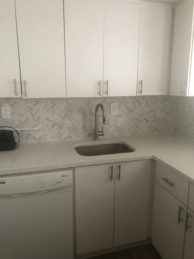 250 180th Dr Unit 108, Sunny Isles Beach, FL 33160 - kitchen with dishwasher, a sink, tasteful backsplash, and white cabinetry