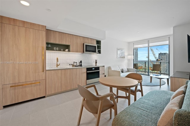 601 NE 1st Ave Unit 3504, Miami, FL 33132 - kitchen featuring stainless steel appliances, open shelves, modern cabinets, a sink, and floor to ceiling windows