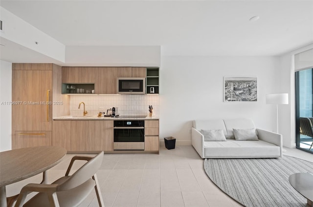 601 NE 1st Ave Unit 3504, Miami, FL 33132 - living room featuring bar with sink, light tile patterned floors, and baseboards