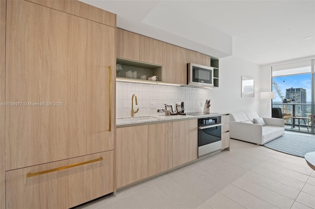 601 NE 1st Ave Unit 3504, Miami, FL 33132 - kitchen with oven, open shelves, a sink, stainless steel microwave, and tasteful backsplash