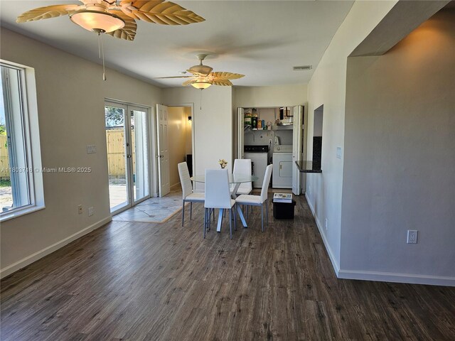 8240 NW 15th St, Pembroke Pines, FL 33024 - dining space featuring washing machine and clothes dryer, dark wood finished floors, a ceiling fan, and baseboards