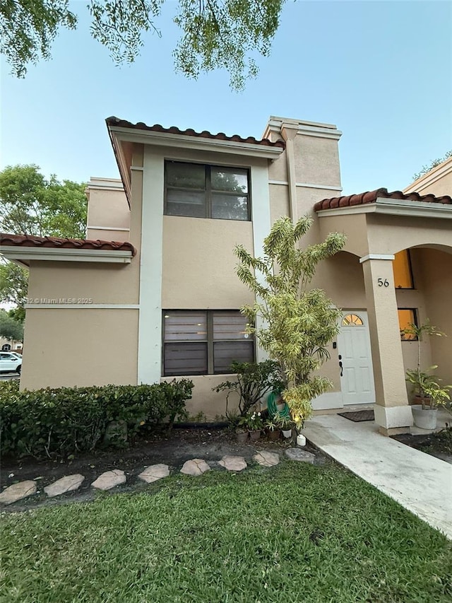 513 Racquet Club Rd Unit 56, Weston, FL 33326 - view of front of property with a tiled roof, stucco siding, and a front yard