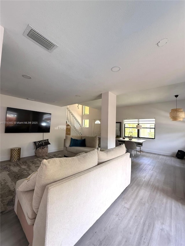 513 Racquet Club Rd Unit 56, Weston, FL 33326 - living room with stairs, a textured ceiling, and wood finished floors