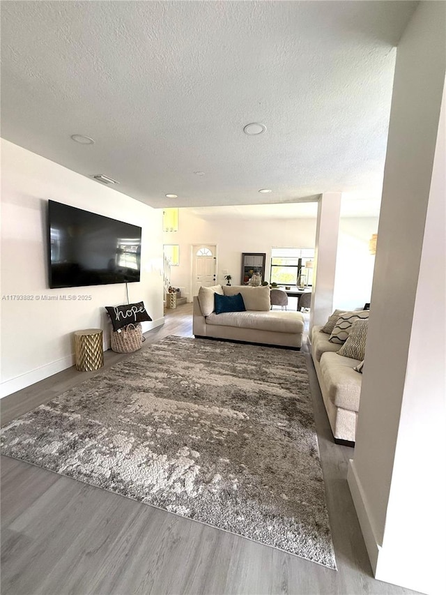 513 Racquet Club Rd Unit 56, Weston, FL 33326 - living area featuring a textured ceiling and wood finished floors