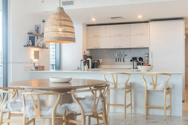 1300 S Miami Ave Unit 2006, Miami, FL 33130 - kitchen with tasteful backsplash, open shelves, pendant lighting, white cabinetry, and light countertops