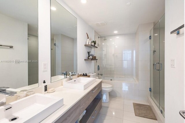 1300 S Miami Ave Unit 2006, Miami, FL 33130 - full bathroom featuring a tile shower, tile patterned flooring, toilet, double vanity, and recessed lighting