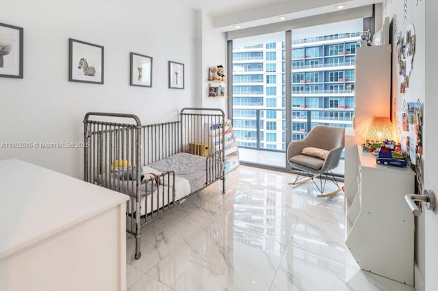 1300 S Miami Ave Unit 2006, Miami, FL 33130 - bedroom with multiple windows, light marble finish floors, a nursery area, and a wall of windows