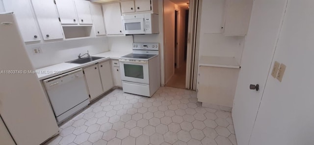 251 174th St Unit 1711, Sunny Isles Beach, FL 33160 - kitchen with white appliances, a sink, light countertops, white cabinetry, and light tile patterned floors