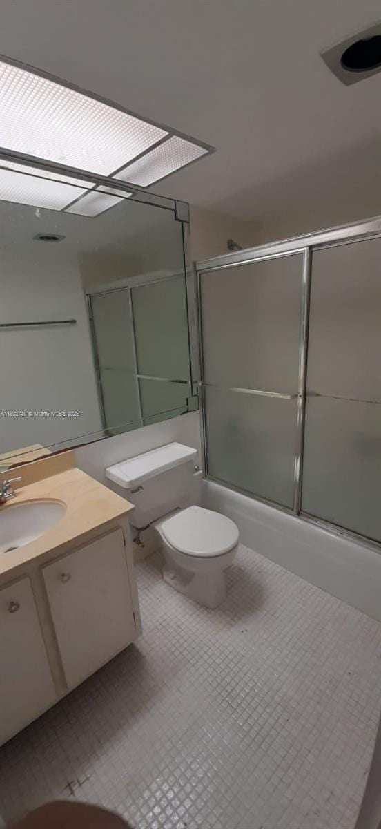 251 174th St Unit 1711, Sunny Isles Beach, FL 33160 - bathroom featuring toilet, bath / shower combo with glass door, and vanity