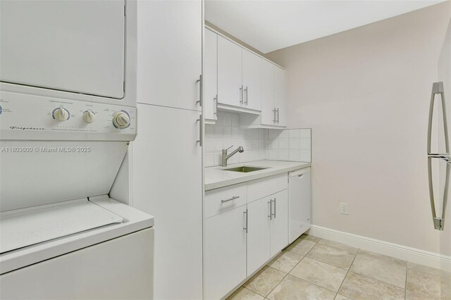 7915 SW 86th St Unit 705, Miami, FL 33143 - laundry area featuring stacked washer / drying machine, light tile patterned flooring, and baseboards