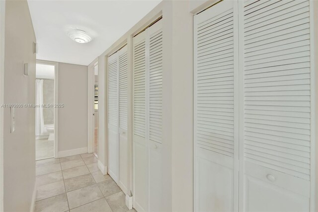 7915 SW 86th St Unit 705, Miami, FL 33143 - hallway with light tile patterned floors and baseboards