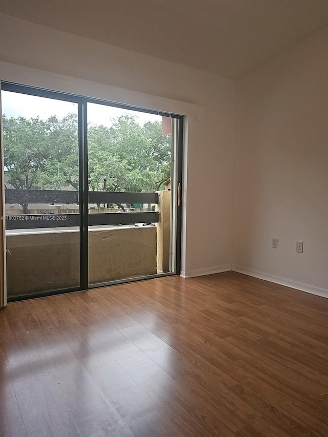 unfurnished room featuring wood finished floors and baseboards