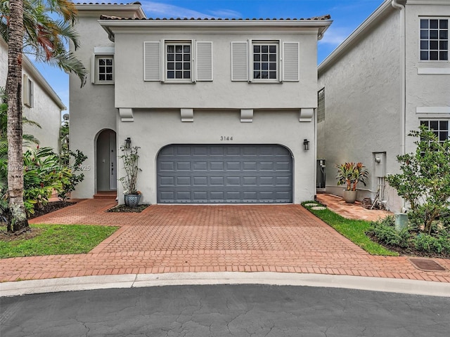 3144 NE 212th St, Aventura, FL 33180 - mediterranean / spanish home with an attached garage, decorative driveway, and stucco siding