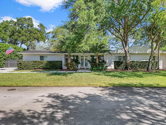 7945 SW 98th Ter, Miami, FL 33156 - ranch-style home with stucco siding, a front yard, and french doors