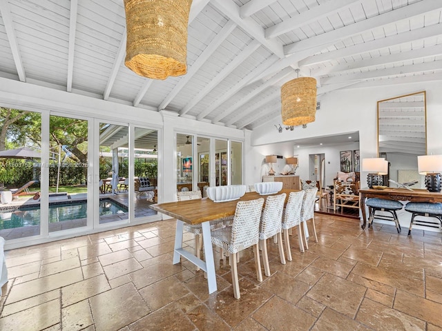 7945 SW 98th Ter, Miami, FL 33156 - dining space featuring stone tile flooring, high vaulted ceiling, and beam ceiling