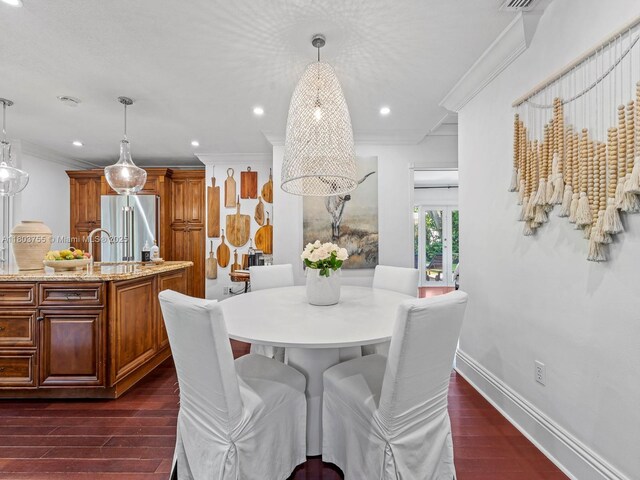 7945 SW 98th Ter, Miami, FL 33156 - dining space featuring dark wood finished floors, crown molding, recessed lighting, and baseboards